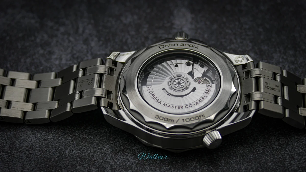 Rückseite einer OMEGA mit sichtbarem Co-Axial-Uhrwerk und Edelstahlband